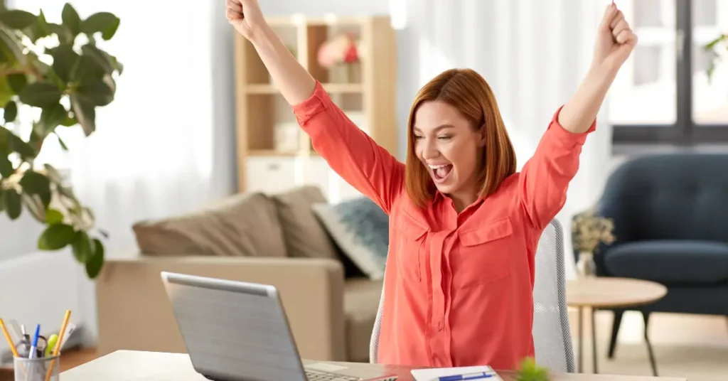 Professional creating a winning resume for remote jobs on a laptop, in a home office.